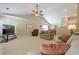Open living room with vaulted ceiling featuring neutral walls, ceiling fan, and ample seating at 2870 Jay Oak Dr, Dacula, GA 30019