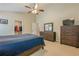 Comfortable main bedroom with neutral carpet, a ceiling fan, and a dresser set at 2870 Jay Oak Dr, Dacula, GA 30019