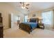 Relaxing main bedroom with vaulted ceiling, ceiling fan, and ensuite bathroom access at 2870 Jay Oak Dr, Dacula, GA 30019