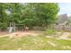 Fenced backyard featuring a wood playground set with slide, swing, and a garden at 2870 Jay Oak Dr, Dacula, GA 30019