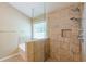 Shower with tiled walls, a bench seat, glass door, and a rainfall shower head at 2870 Jay Oak Dr, Dacula, GA 30019