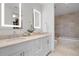Elegant bathroom with double vanity, backlit mirrors, and tile flooring at 3630 Peachtree Ne Rd # 2309, Atlanta, GA 30326