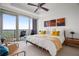 Bright bedroom featuring a ceiling fan, balcony, and stunning treetop views at 3630 Peachtree Ne Rd # 2309, Atlanta, GA 30326