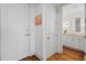 Bright hallway with wood floors leads to a bathroom with modern fixtures and vanity at 3630 Peachtree Ne Rd # 2309, Atlanta, GA 30326