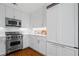 Modern kitchen featuring stainless steel appliances, white cabinets, and quartz countertops and backsplash at 3630 Peachtree Ne Rd # 2309, Atlanta, GA 30326