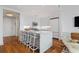 Open kitchen featuring a quartz island with seating, stainless steel appliances, and hardwood floors at 3630 Peachtree Ne Rd # 2309, Atlanta, GA 30326