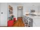 Bright, open kitchen with a quartz waterfall island, seating, modern stools, and hardwood floors at 3630 Peachtree Ne Rd # 2309, Atlanta, GA 30326