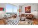 Stylish living room with hardwood floors, designer rug, and floor-to-ceiling windows at 3630 Peachtree Ne Rd # 2309, Atlanta, GA 30326