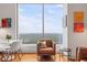 Cozy living room featuring comfortable seating, hardwood floors, and large windows with scenic treetop views at 3630 Peachtree Ne Rd # 2309, Atlanta, GA 30326