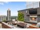 Outdoor rooftop terrace features a stone fireplace, TV, seating, and views of the city at 3630 Peachtree Ne Rd # 2309, Atlanta, GA 30326