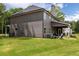 Spacious backyard with lush green lawn and covered patio, ideal for outdoor gatherings or quiet relaxation at 415 Paynes Lake Rd, Carrollton, GA 30116