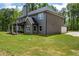 Beautiful home featuring a spacious lawn, a covered porch, and a serene outdoor setting, perfect for relaxation at 415 Paynes Lake Rd, Carrollton, GA 30116