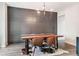 Modern dining room features a rustic wood table, leather chairs, a cow hide rug, and a stylish chandelier at 415 Paynes Lake Rd, Carrollton, GA 30116