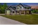Lovely two-story home with beautiful landscaping and a welcoming front porch, bathed in the evening light at 415 Paynes Lake Rd, Carrollton, GA 30116