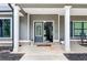 Inviting front porch with classic columns, showcasing a charming entrance and cozy rocking chair at 415 Paynes Lake Rd, Carrollton, GA 30116