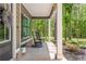 Cozy front porch featuring rocking chairs, potted plants, and a charming view of the surrounding trees at 415 Paynes Lake Rd, Carrollton, GA 30116