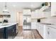 Well-lit kitchen with stainless steel appliances, an island with sink, and lots of storage space at 415 Paynes Lake Rd, Carrollton, GA 30116