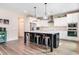 Bright kitchen with island seating, modern stainless appliances, and trendy pendant lighting at 415 Paynes Lake Rd, Carrollton, GA 30116