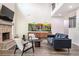 This open concept living room boasts a fire place, a vaulted ceiling, hardwood floors, and modern furniture at 415 Paynes Lake Rd, Carrollton, GA 30116
