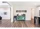 Open concept living space with decorative cabinet, hardwood floors, and easy access to the kitchen at 415 Paynes Lake Rd, Carrollton, GA 30116