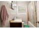 This bathroom features a vanity, sink, toilet and bathtub with a shower and a floral shower curtain at 5343 Crystal Ln, Atlanta, GA 30349