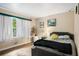 Comfortable bedroom with a large window, warm tones, and wood floors at 5343 Crystal Ln, Atlanta, GA 30349