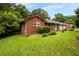 Charming brick home with a well-manicured lawn and mature trees providing shade and curb appeal at 5343 Crystal Ln, Atlanta, GA 30349