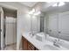 Bright bathroom featuring a double vanity, large mirror, and shower with decorative curtain at 1058 Magnolia Dr, Villa Rica, GA 30180