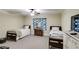 Bedroom with two beds, dresser, carpeted floor, and colorful floral curtains at 1058 Magnolia Dr, Villa Rica, GA 30180