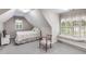 Bright bedroom featuring window seat, TV, neutral tones, and gray carpet at 1058 Magnolia Dr, Villa Rica, GA 30180