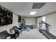 Basement gym featuring a treadmill, weight machine, and wicker chairs at 1058 Magnolia Dr, Villa Rica, GA 30180