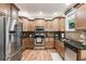 Modern kitchen with stainless steel appliances, granite countertops, hardwood floors, and ample cabinet space at 1058 Magnolia Dr, Villa Rica, GA 30180