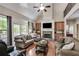 Comfortable living room with a stone fireplace, built-in cabinets, and hardwood floors, great for Gathering gatherings at 1058 Magnolia Dr, Villa Rica, GA 30180