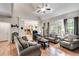 Spacious living room with hardwood floors, vaulted ceilings, large windows, fireplace, and open access to the kitchen at 1058 Magnolia Dr, Villa Rica, GA 30180
