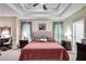 Tranquil main bedroom boasts a tray ceiling and decorative lamps, with dual bedside tables at 1058 Magnolia Dr, Villa Rica, GA 30180