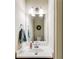 Cozy powder room with a decorative wreath, a round basin sink, and tiled walls at 1058 Magnolia Dr, Villa Rica, GA 30180