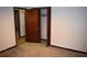 Carpeted bedroom with a closet and access to other rooms at 157 Sequoyah Cir, Canton, GA 30115