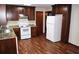 A kitchen with brown wood cabinetry, laminate counter tops, and modern white appliances at 157 Sequoyah Cir, Canton, GA 30115