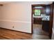 Open living space featuring wood-look floors and a glimpse into the kitchen at 157 Sequoyah Cir, Canton, GA 30115