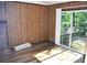 A living room featuring wood paneled walls, a fireplace, and sliding glass doors to the outside at 157 Sequoyah Cir, Canton, GA 30115