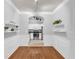 Dining room features hardwood floors, white molding, and open access to the white kitchen at 1850 Cotillion Dr # 3123, Atlanta, GA 30338