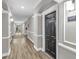 Long hallway with wood floors and neutral walls leading to the apartment entrance at 1850 Cotillion Dr # 3123, Atlanta, GA 30338