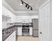 Well-equipped kitchen featuring white cabinets, stainless steel appliances, and granite countertops at 1850 Cotillion Dr # 3123, Atlanta, GA 30338