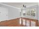 Inviting living room with gleaming hardwood floors, three windows and an entrance to the patio at 1850 Cotillion Dr # 3123, Atlanta, GA 30338