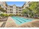 A luxurious condo community pool with multiple lounge chairs for relaxing in the sun on the pool deck at 1850 Cotillion Dr # 3123, Atlanta, GA 30338