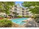 Outdoor pool with lounge chairs surrounded by green landscaping at 1850 Cotillion Dr # 3123, Atlanta, GA 30338