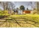 Backyard view of home, showing lawn, deck, and mature trees at 236 Barfield Sw Ave, Atlanta, GA 30310
