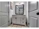 Bathroom with gray vanity, new mirror, and tiled floor at 236 Barfield Sw Ave, Atlanta, GA 30310