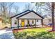 Charming renovated home featuring a covered front porch and a bright yellow door at 236 Barfield Sw Ave, Atlanta, GA 30310