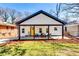 Charming renovated home featuring a covered front porch and a bright yellow door at 236 Barfield Sw Ave, Atlanta, GA 30310